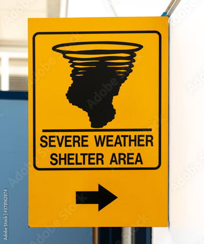 Yellow sign indicating a severe weather shelter area photo