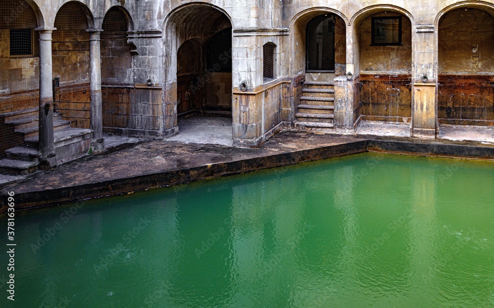 water and buildings in an old roman bath in the city of Bath in the united kingdom water and buildings in an old roman bath in the city of Bath in the united kingdom