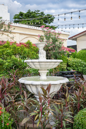 Carved stone fountain in ornamental garden