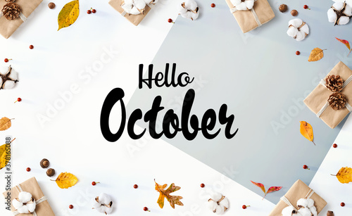 Hello October message with gift boxes with autumn leaves