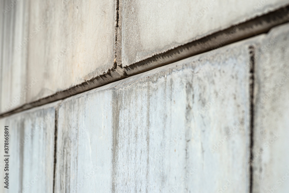 Background, texture made of large concrete blocks with visible joints, close-up photo.