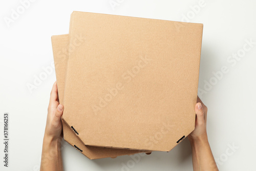 Hands hold boxes with tasty pizza, top view © Atlas