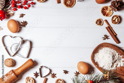 Ingredients for baking new year cookies on a white wooden background, copy space