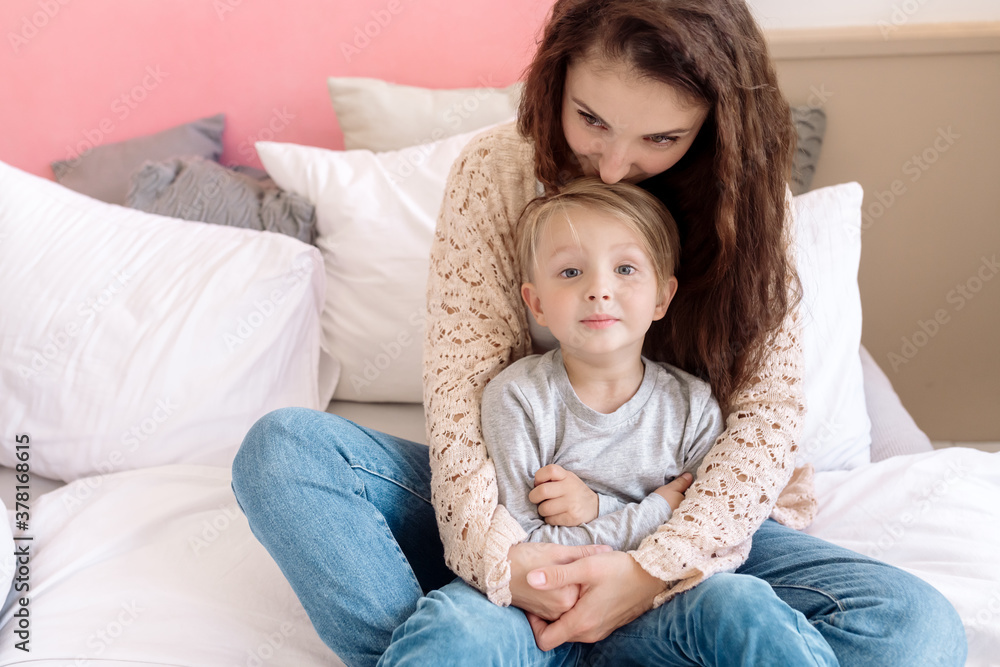 Mom and son 5 years old are sitting embracing on the bed in the bedroom
Mom and son 5 years old are sitting embracing on the bed in the bedroom