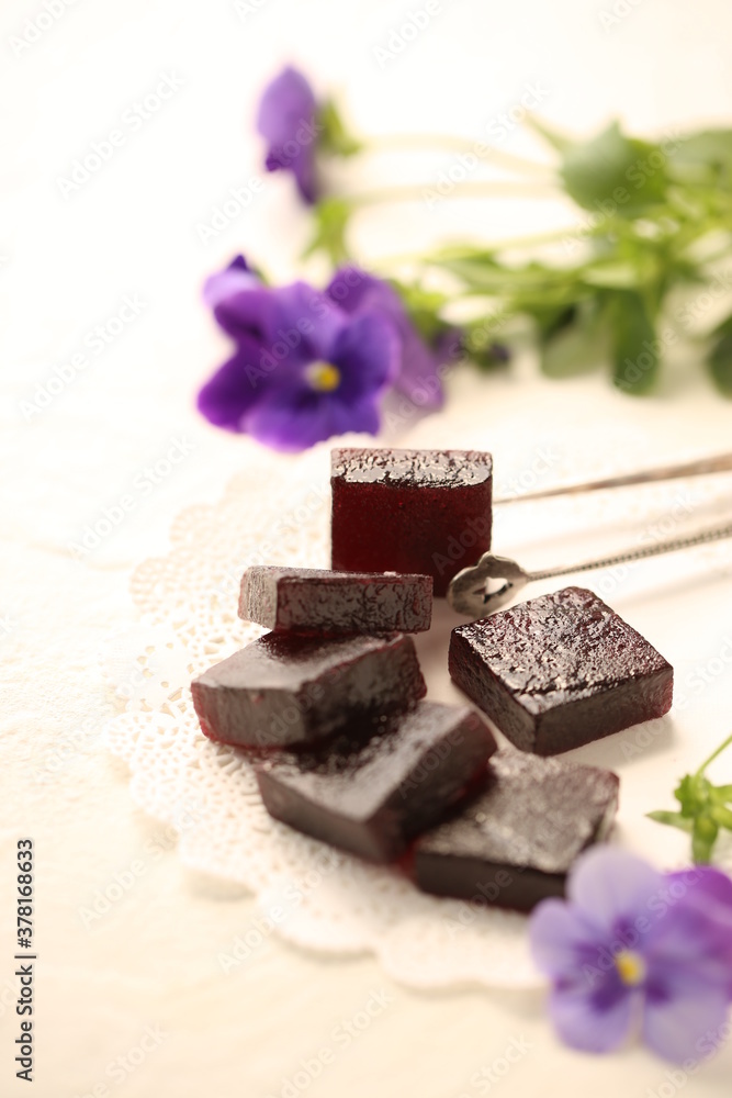 Handmade marmalade of dark color from grapes, on a white background.
Handmade marmalade of dark color from grapes, on a white background.