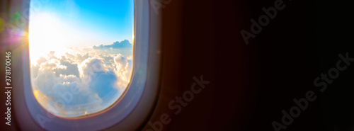 Sunrise through airplane window with copyspace banner photo