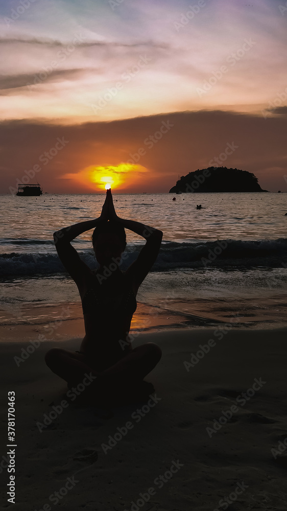 girl yoga on the beach at sunset