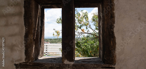 ventana antigua con arboles en el extrior photo