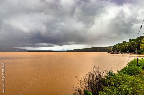 pristine landscape with lake calm water and dramatic sky at morning from flat angle photo