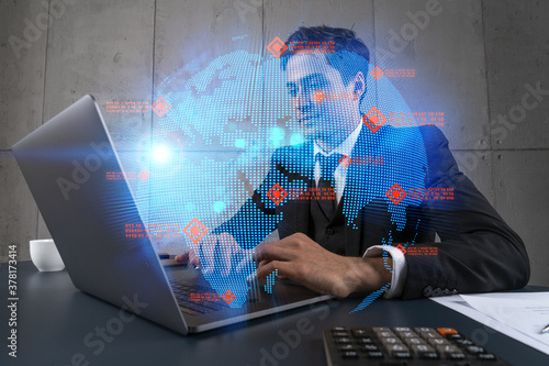 Businessman in office working with laptop, world map planet earth hologram, typing computer. Double exposure.