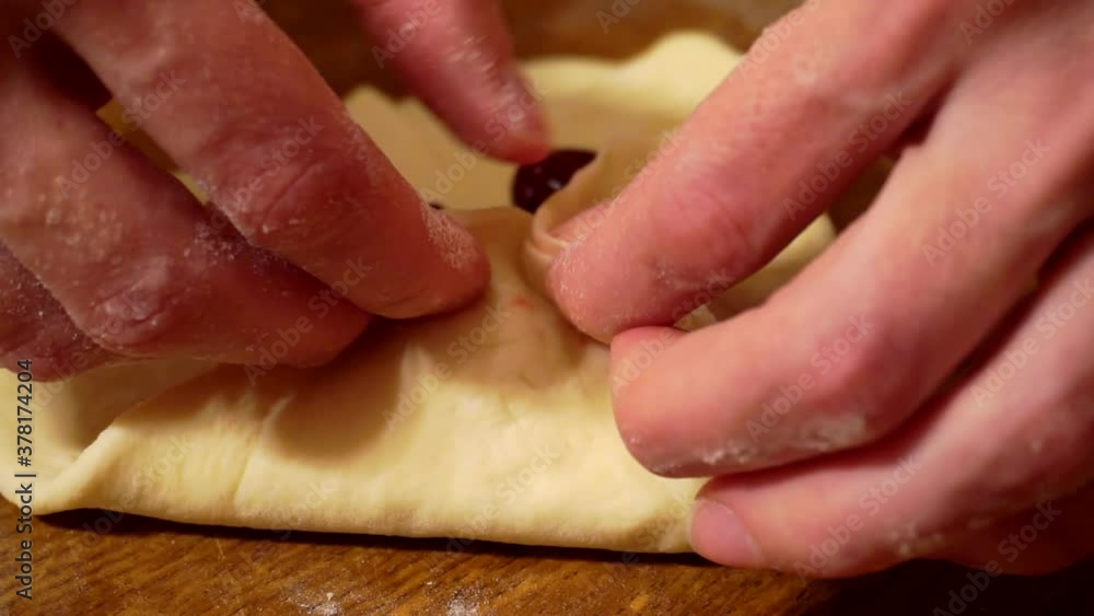 female hands work with dough on a wooden table.close-up. female hands work with dough on a wooden table.close-up.