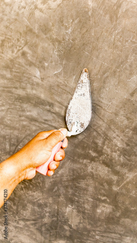 Tiler's hand.bricklayer plaster a wall inside a building