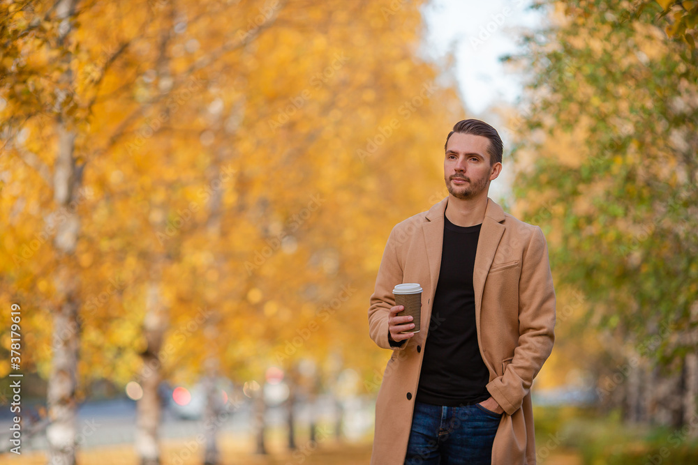 Young man in autumn in the park outdoors Young man in autumn in the park outdoors