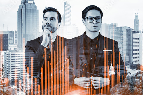 Canvas Print Two young handsome businessman in suits dreaming about new career opportunities after MBA graduation