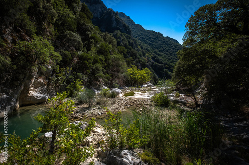 Small river enveloped with rocks. Closeup of river scenes in forest in Epirus Greece.