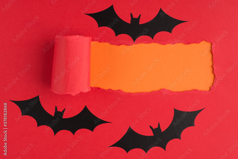 Top above overhead view close-up photo of torn red paper and bats over orange background with copyspace