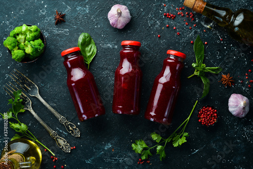 Spicy cranberry sauce in jars. Top view. Rustic style.