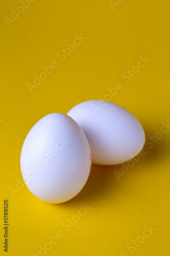 .chicken eggs on yellow background