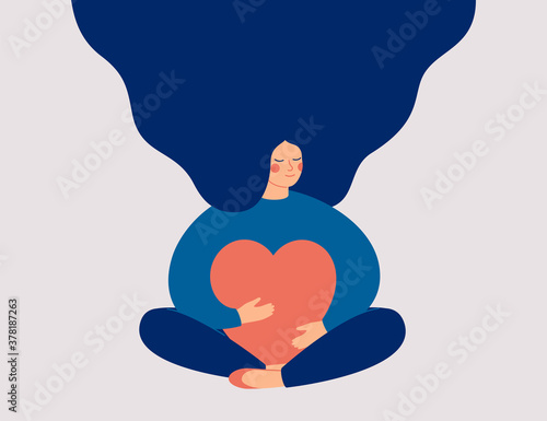 Young woman embraces a big red heart with mindfulness and love. Smiling female character sits in lotos pose with closed eyes and enjoys her freedom and life. Body positive and mental health concept. photo
