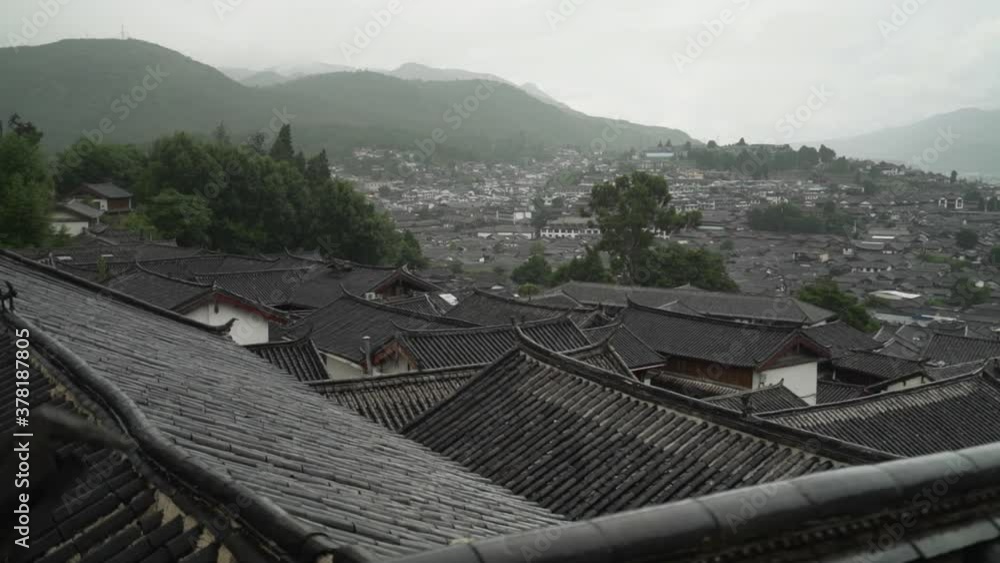 Historic Lijiang Old Town Rooftops on a Rainy Cloudy Day - Slow Pan Across Anicent City - Historic Lijiang Old Town Rooftops on a Rainy Cloudy Day - Slow Pan Across Anicent City -