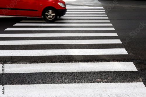Canvas-taulu image of a red car at a crosswalk