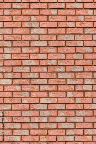 Wall cladded with red decorative bricks, front view. Material for decorating the construction wall