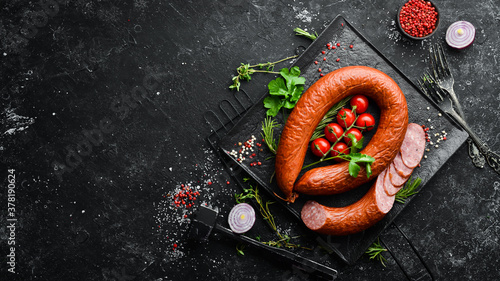 Obraz na plátně Smoked sausage ring with spices and herbs