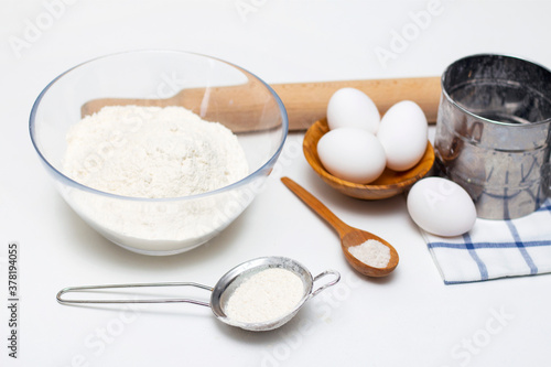 making dough for bread or homemade baked goods. ingredients on the table. against the background of a bright modern kitchen