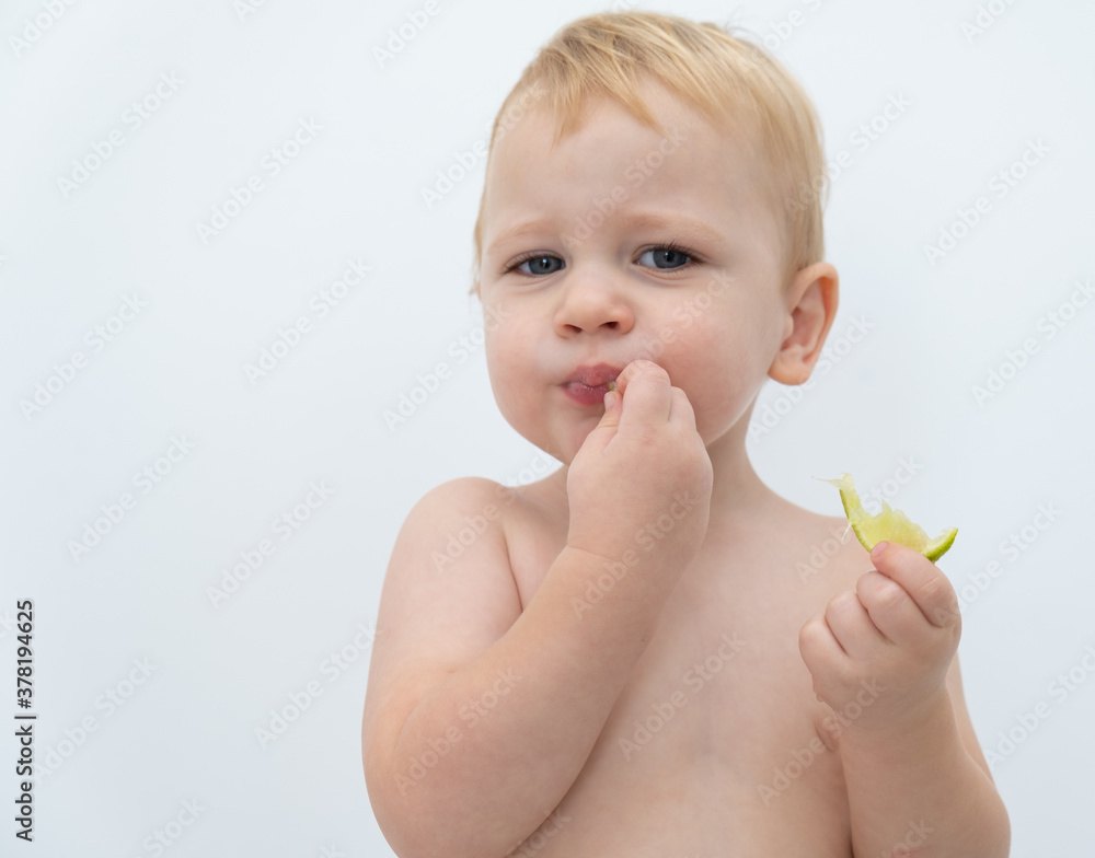 Baby boy trying and tasting new food. Dieting, vegetarian and healthy nutrition concept. Baby boy trying and tasting new food. Dieting, vegetarian and healthy nutrition concept.