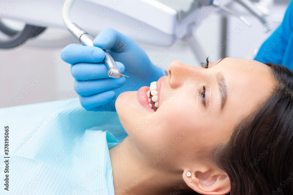 Dentist and patient in the dental office. Woman having teeth examined by dentists Dentist and patient in the dental office. Woman having teeth examined by dentists