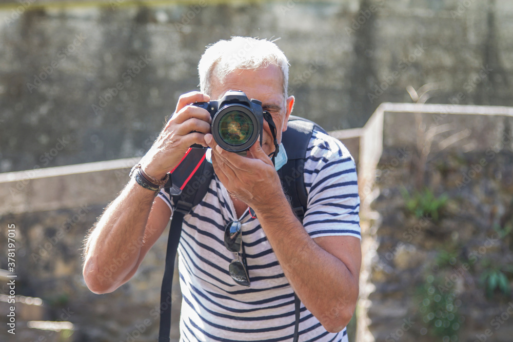 tourist taking photos with his digital camera tourist taking photos with his digital camera