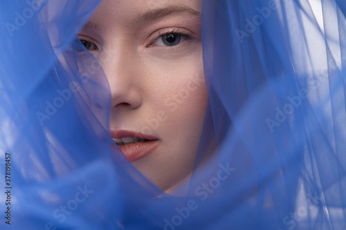 Attractive young woman wearing beautiful blue veil