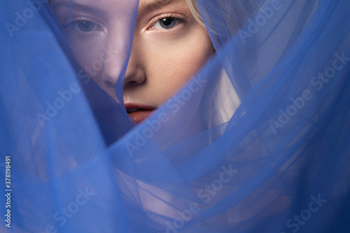 Charming young woman wearing beautiful blue veil
