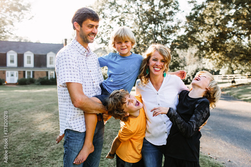 Happy Family Together in Their Front Yard