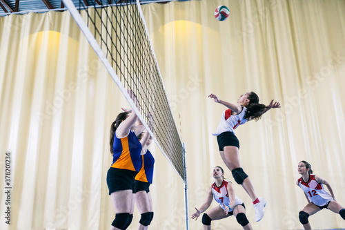 Focused female volleyball player blocking served ball while tournament in Madrid, Spain. photo