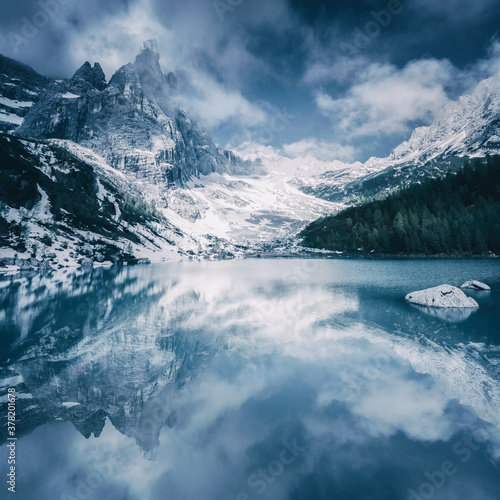 Scenic view of mountain Dito di Dio reflecting in Sorapiss Lake in winter photo