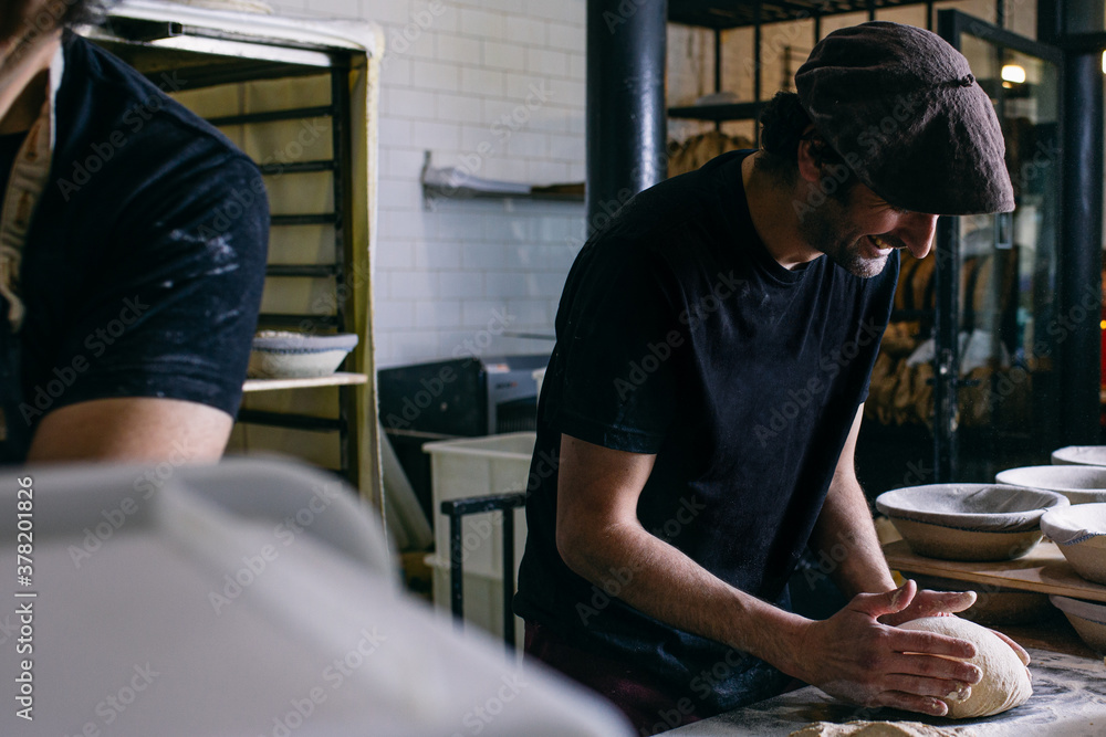 Baker forming bread with hands Baker forming bread with hands