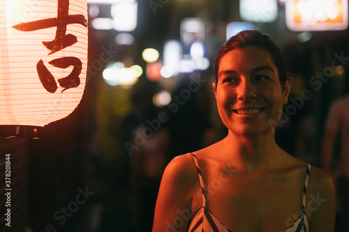 Cheerful woman on night street in Tokyo, Japan photo