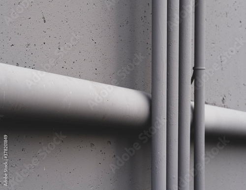 Electrical piping and drainage pipe on building wall