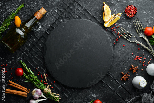 Dark background of food, vegetables and spices. Top view. Free space for text.