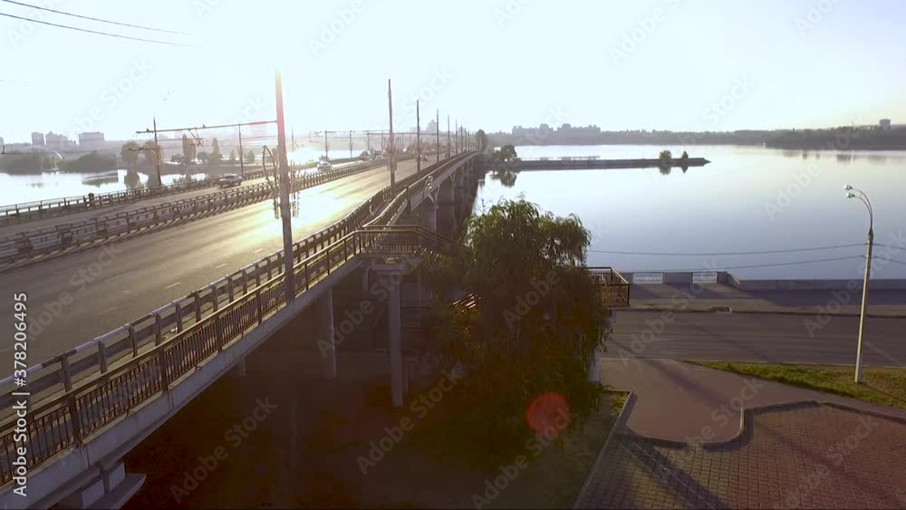 Bright rays of the sun illuminate the busy road bridge. Dam, island, Voronezh Bright rays of the sun illuminate the busy road bridge. Dam, island, Voronezh