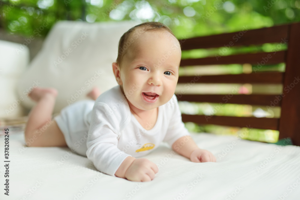 Cute three months old baby boy lying on his tummy. Baby during tummy time. Cute child learning to crawl. Cute three months old baby boy lying on his tummy. Baby during tummy time. Cute child learning to crawl.
