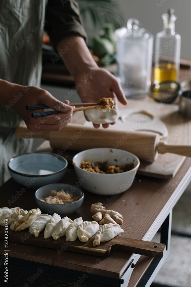 Closeup Of Man's Hands Assembling Homemade Dumplings Closeup Of Man's Hands Assembling Homemade Dumplings