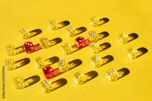 Yellow and red dice on yellow paper photo