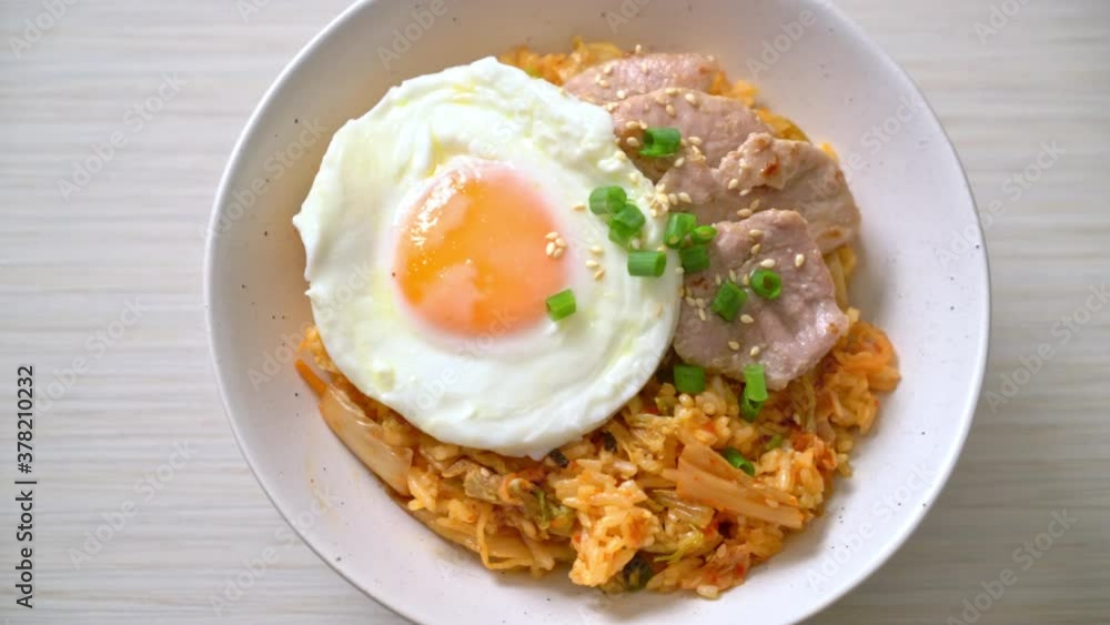 Kimchi fried rice with fried egg and pork - Korean food style Kimchi fried rice with fried egg and pork - Korean food style