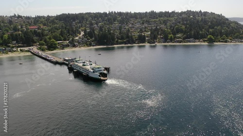 Drone / aerial footage of the docked ferry at the ferry terminal with cars loading and unloading in Fountleroy, near Lincoln Park and Seattle, Washington photo