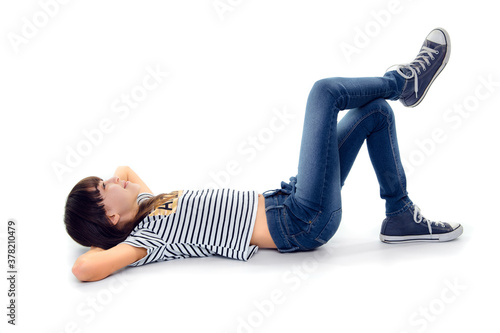 10 year old girl look up while lie on ground with legs crossed