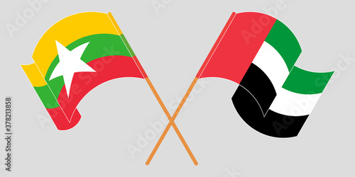 Crossed and waving flags of Myanmar and the United Arab Emirates