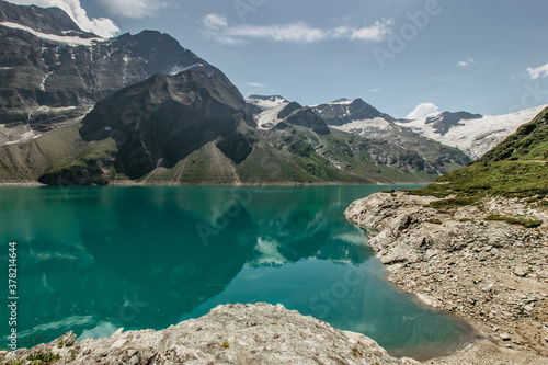 Beautiful view of high mountain lake near Kaprun.Hike to the Mooserboden dam in Austrian Alps.Quiet relaxation in nature.Wonderful nature landscape,turquoise tranquil lake,holiday travel scene,