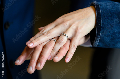 Man and woman show wedding rings.